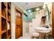 Bathroom featuring a unique sink and shower with tiled walls at 2409 E Cedar Ave, Denver, CO 80209