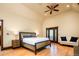 Bright main bedroom includes a ceiling fan, hardwood floors, and French door access to the outdoors at 2409 E Cedar Ave, Denver, CO 80209