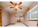 Finished bedroom with a ceiling fan, carpeted floors and a shuttered window at 2409 E Cedar Ave, Denver, CO 80209