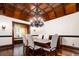 Formal dining room featuring a decorative chandelier, hardwood floors, and a bay window at 2409 E Cedar Ave, Denver, CO 80209