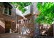 Charming brick home exterior featuring lush greenery, brickwork details, and classic lighting fixtures at 2409 E Cedar Ave, Denver, CO 80209