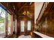 Elegant foyer with wooden staircase, high ceilings, and large windows offering abundant natural light at 2409 E Cedar Ave, Denver, CO 80209