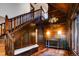 Grand foyer featuring wood paneling, staircase, chandelier, and hardwood floors at 2409 E Cedar Ave, Denver, CO 80209