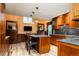 This kitchen offers custom wood cabinets, granite countertops, bar seating, and high-end stainless appliances at 2409 E Cedar Ave, Denver, CO 80209