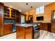 Gourmet kitchen features custom cabinets, a granite island, and high-end stainless steel appliances at 2409 E Cedar Ave, Denver, CO 80209