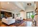 Open concept living room featuring fireplace and hardwood floors at 2409 E Cedar Ave, Denver, CO 80209