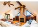 Living room with a brick fireplace, wood beams, couches, and natural light at 2409 E Cedar Ave, Denver, CO 80209