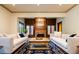 Spacious living room with brick fireplace and hardwood floors at 2409 E Cedar Ave, Denver, CO 80209