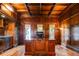Executive office with custom wood paneling, built-in cabinets, and a large wooden desk at 2409 E Cedar Ave, Denver, CO 80209