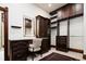 Closet with a vanity area, drawers, a mirror, and ample dark wood shelving for clothes and storage at 2409 E Cedar Ave, Denver, CO 80209