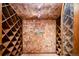Intimate wine cellar with dark wood racking, tiled walls and floors, and custom decor at 2409 E Cedar Ave, Denver, CO 80209