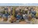 Panoramic aerial shot of a residential area with lush trees, manicured lawns, and charming homes, promoting neighborhood appeal at 16200 Quarry Hill Dr, Parker, CO 80134