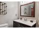 Elegant bathroom with a dark wood vanity, marble countertop, and stylish mirror, creating a relaxing ambiance at 16200 Quarry Hill Dr, Parker, CO 80134