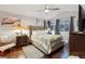 Well-lit bedroom with hardwood floors, ceiling fan, neutral walls and large windows at 16200 Quarry Hill Dr, Parker, CO 80134