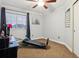 Bright bedroom with a Total Gym XLS exercise machine and plenty of natural light from the large window at 16200 Quarry Hill Dr, Parker, CO 80134
