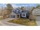 Charming two-story home with stone accents, a well-kept lawn, and a welcoming entrance, showcasing curb appeal at 16200 Quarry Hill Dr, Parker, CO 80134
