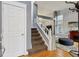 Inviting foyer with staircase, hardwood floors, and views to the living area, creating a warm welcome at 16200 Quarry Hill Dr, Parker, CO 80134