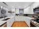 Modern kitchen with white cabinets, quartz countertops, and stainless steel appliances at 16200 Quarry Hill Dr, Parker, CO 80134