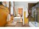 Bathroom with modern sink, tan marble counter, and an opening to a bedroom with a brick wall at 416 W 3Rd Ave, Denver, CO 80223