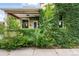 Charming front porch with brick and tan trim covered in a lush green vine facade at 416 W 3Rd Ave, Denver, CO 80223