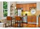 Cozy kitchen with stainless steel appliances, wooden cabinets, granite countertops, and a breakfast bar with seating at 416 W 3Rd Ave, Denver, CO 80223