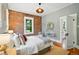 Comfortable main bedroom with exposed brick wall, hardwood floors, and plenty of natural light at 416 W 3Rd Ave, Denver, CO 80223