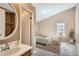 Clean bathroom with vanity, sink, and view into bedroom at 1342 S Idalia St, Aurora, CO 80017