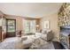 Virtually staged living room with entryway and fireplace at 1342 S Idalia St, Aurora, CO 80017