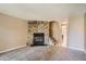 Living room featuring a stone fireplace and carpet flooring at 1342 S Idalia St, Aurora, CO 80017