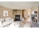 Virtually staged living room with stone fireplace and neutral decor at 1342 S Idalia St, Aurora, CO 80017