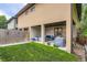 Expansive backyard features a covered patio, manicured lawn, privacy fence, and landscaping at 1916 S Elati St, Denver, CO 80223