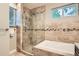Beautiful bathroom featuring a glass-enclosed shower, soaking tub, and modern fixtures at 1916 S Elati St, Denver, CO 80223