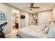 Spacious bedroom featuring plush carpets, ceiling fan, exercise equipment and view into bathroom at 1916 S Elati St, Denver, CO 80223