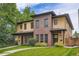 Attractive townhouse with a combination of brick and siding, with a grassy lawn and walkway to the entrance at 1916 S Elati St, Denver, CO 80223
