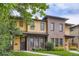 Two-story townhouse with a brick and tan siding, accented by a green lawn at 1916 S Elati St, Denver, CO 80223