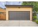 Detached garage with traditional door and adjacent yard space at 1916 S Elati St, Denver, CO 80223