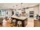 Spacious kitchen with granite countertops, an island with seating, and stainless steel appliances at 1916 S Elati St, Denver, CO 80223