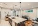 Well-lit kitchen featuring a center island, modern appliances, and an adjacent dining area at 1916 S Elati St, Denver, CO 80223