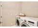 Functional laundry room includes modern washer and dryer, storage space, and neutral paint at 1916 S Elati St, Denver, CO 80223