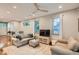 Inviting living room features hardwood floors, a neutral color palette, and a large TV for entertainment at 1916 S Elati St, Denver, CO 80223