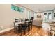 Cozy living room featuring hardwood floors, a dining table and a comfortable sofa at 1916 S Elati St, Denver, CO 80223