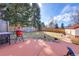 Spacious backyard featuring lush green grass and an orange concrete patio at 3885 Hoyt St, Wheat Ridge, CO 80033