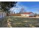 Spacious backyard featuring lush green grass and a sturdy wood fence at 3885 Hoyt St, Wheat Ridge, CO 80033