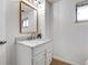 Bathroom vanity features white cabinetry and marble countertop at 3885 Hoyt St, Wheat Ridge, CO 80033