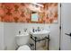 Stylish bathroom features an elegant sink, modern fixtures, and unique wallpaper at 3885 Hoyt St, Wheat Ridge, CO 80033