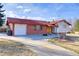 Inviting single-story home with a red roof and a well-maintained front yard, showcasing its curb appeal at 3885 Hoyt St, Wheat Ridge, CO 80033