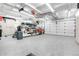 Spacious garage with epoxy flooring, utility sink, and storage cabinets at 3885 Hoyt St, Wheat Ridge, CO 80033