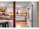 Well-lit kitchen with stainless appliances, white cabinetry, and hardwood floors, perfect for cooking and entertaining at 3885 Hoyt St, Wheat Ridge, CO 80033