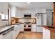 Bright kitchen with white cabinets, stainless steel appliances, and a farmhouse sink at 3885 Hoyt St, Wheat Ridge, CO 80033