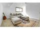 Cozy living room features a comfortable couch, ottomans, and stylish rug at 3885 Hoyt St, Wheat Ridge, CO 80033